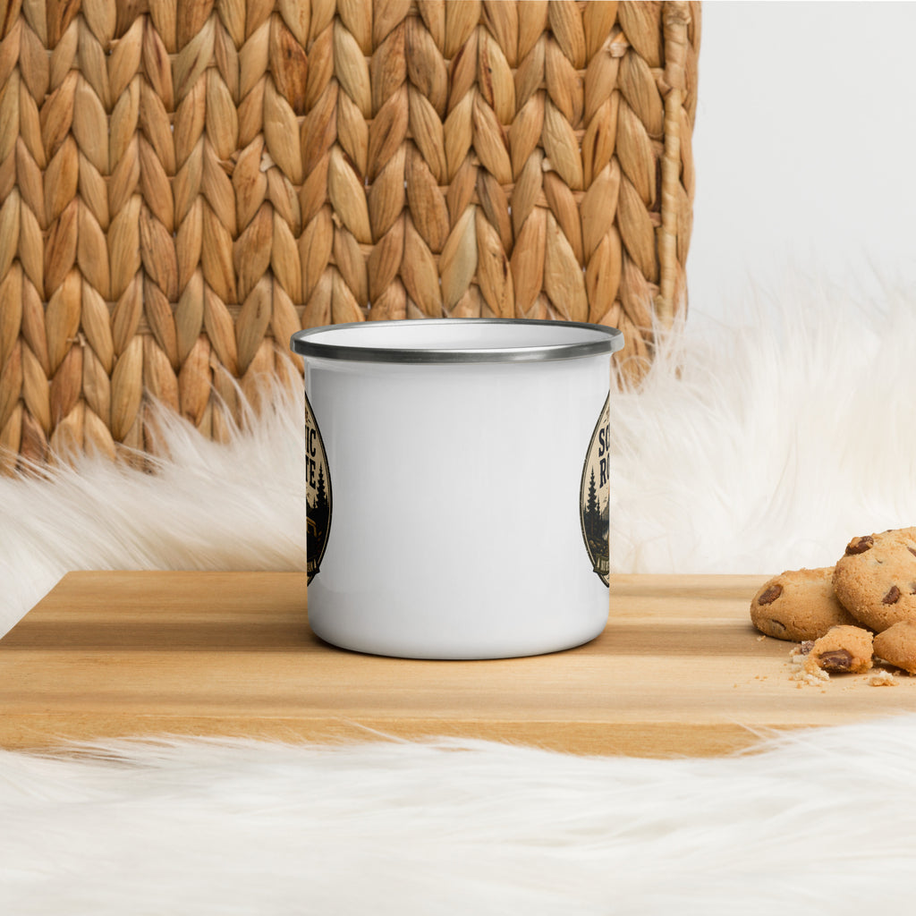 White enamel mug with silver rim on tabletop, Scenic Route logo front