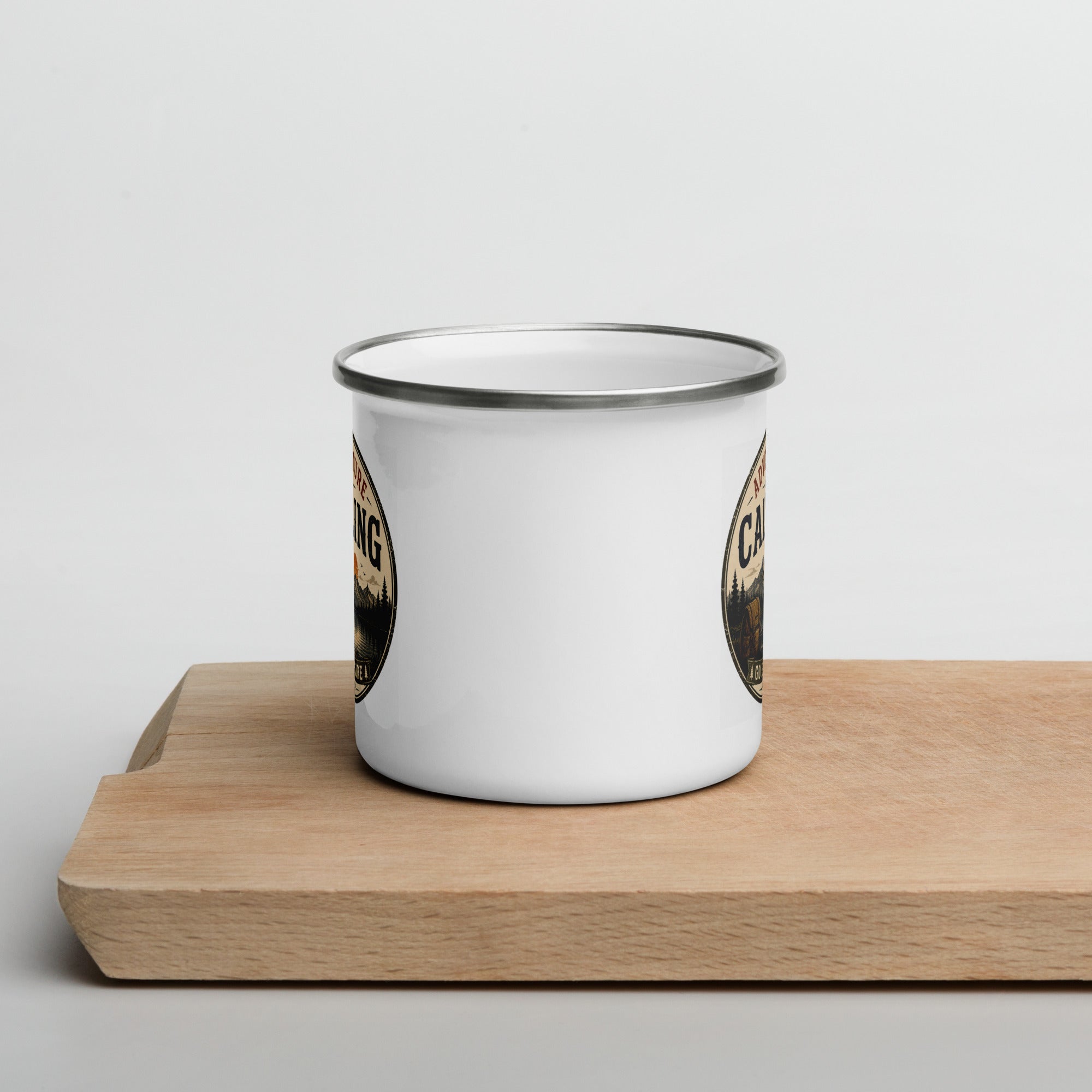 White enamel mug with silver rim, partial 'Adventure Is Calling' print on side