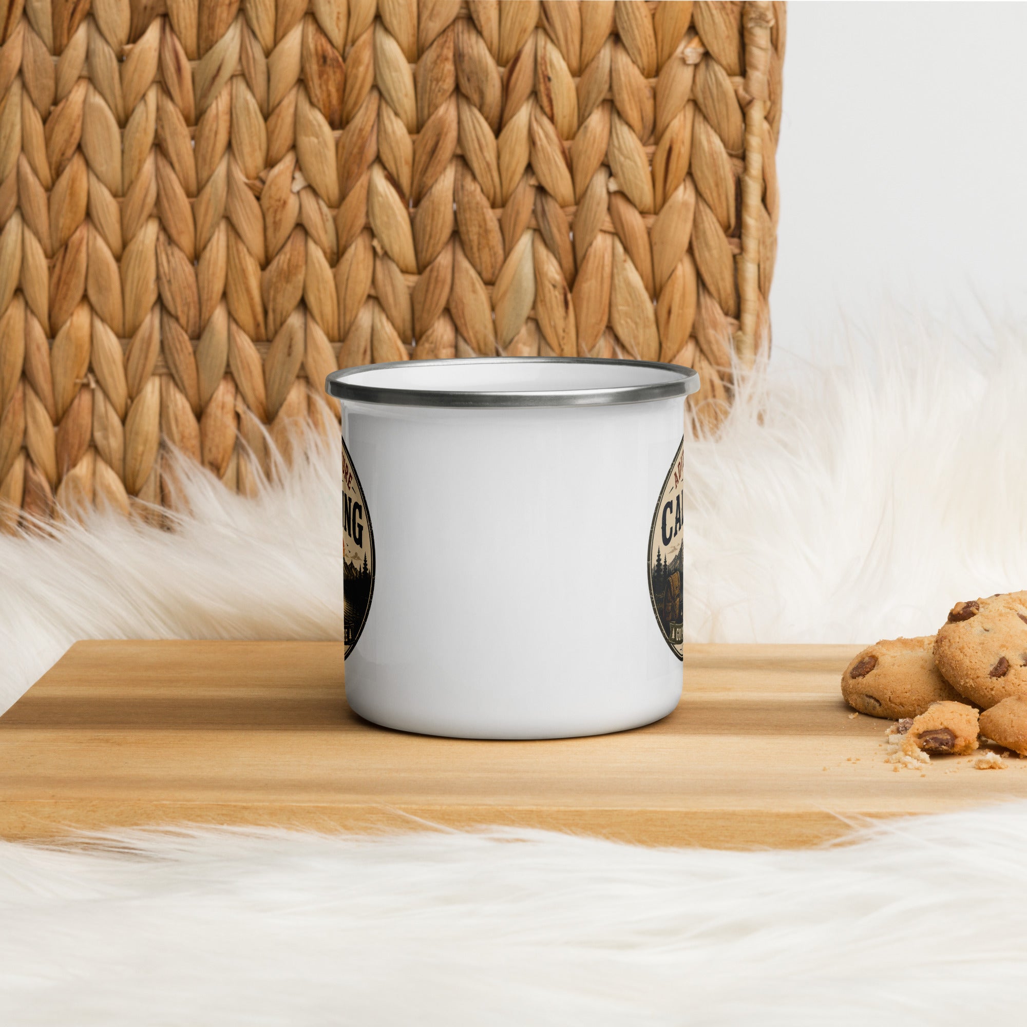 White enamel mug with silver rim on a wooden surface, partial “Adventure is Calling” print.