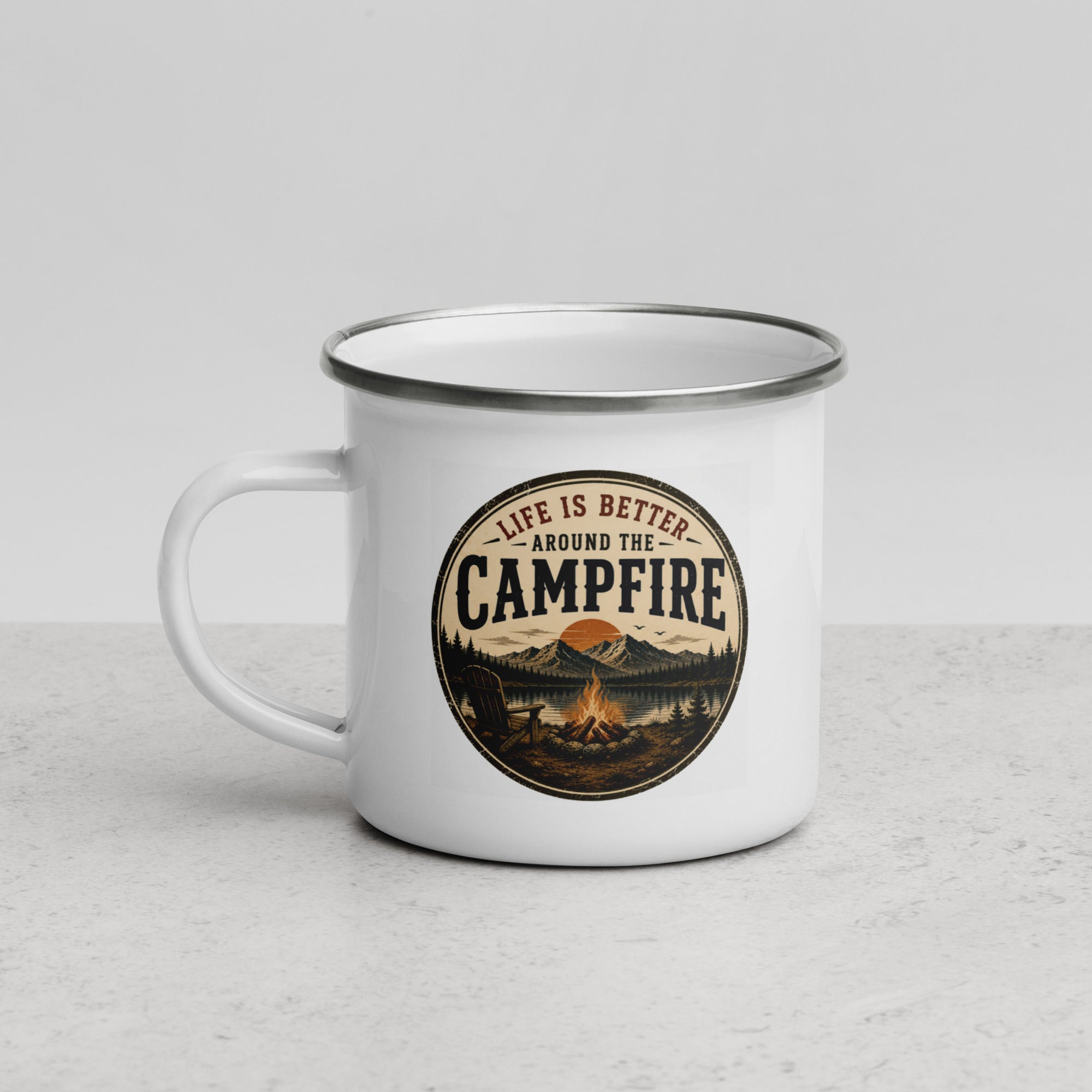 White enamel mug with silver rim and handle, angled view of 'Campfire' logo graphic