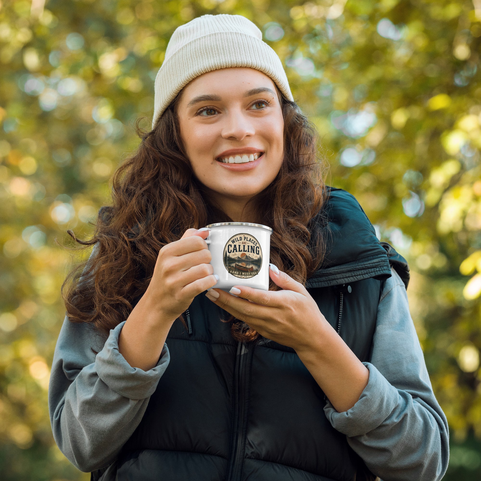 White enamel mug held in hands, silver rim and calling logo visible