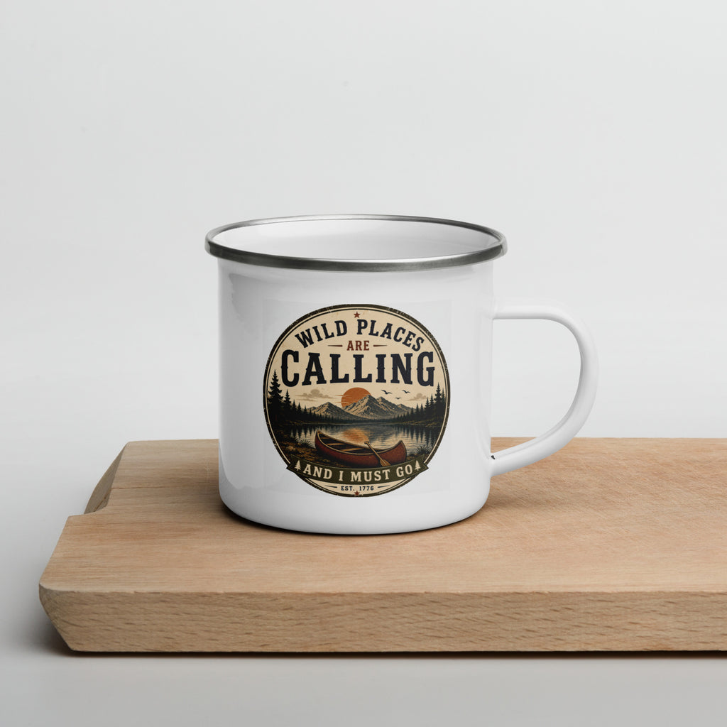White enamel mug with silver rim and front graphic "WILD PLACES ARE CALLING" on wooden base