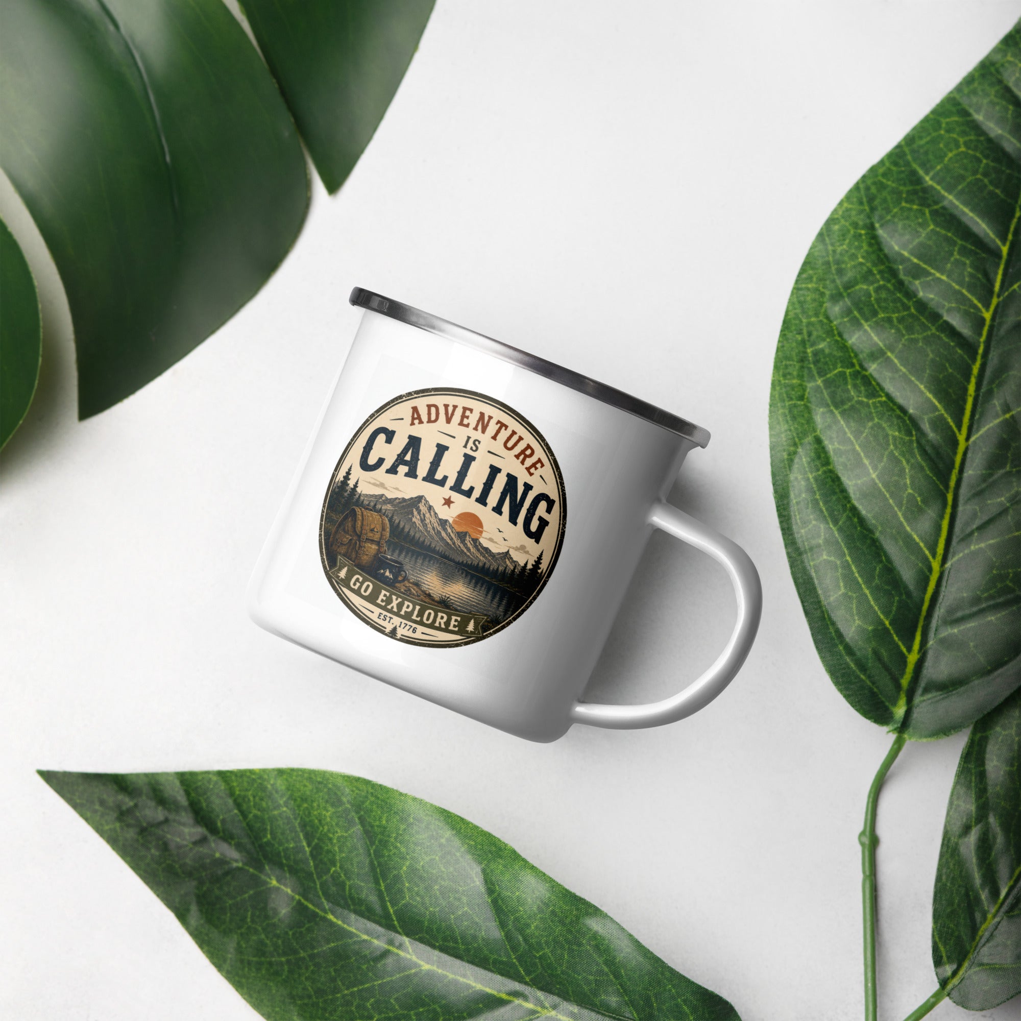 White enamel mug with silver rim, 'Adventure Is Calling' logo, side handle view