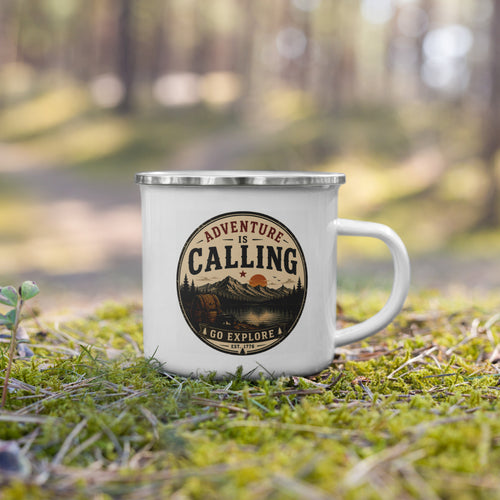 White enamel mug with silver rim standing on grass, “Adventure is Calling” logo.