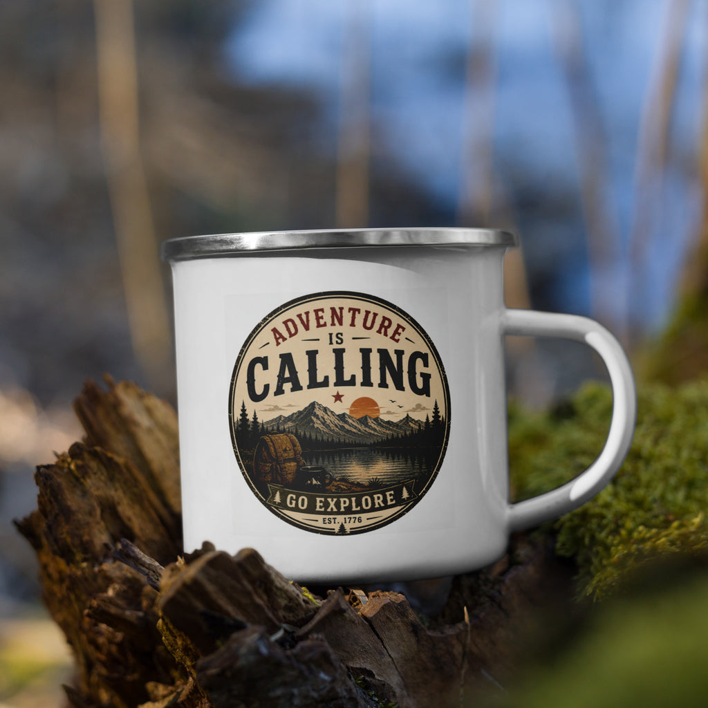 White enamel mug with silver rim on wood outdoors, “Adventure is Calling” logo.