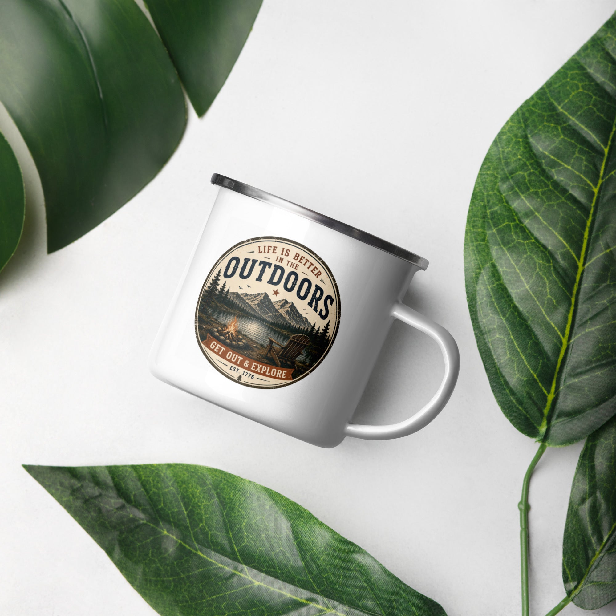 White enamel mug with black rim, Outdoors badge logo, close-up