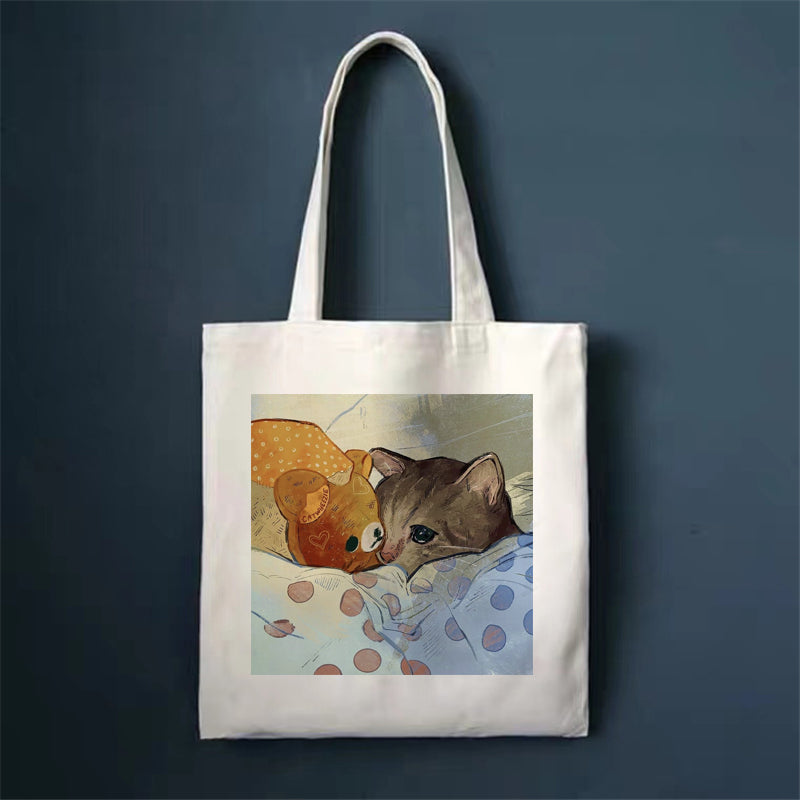 Canvas tote bag, white, with brown cat and teddy bear print.