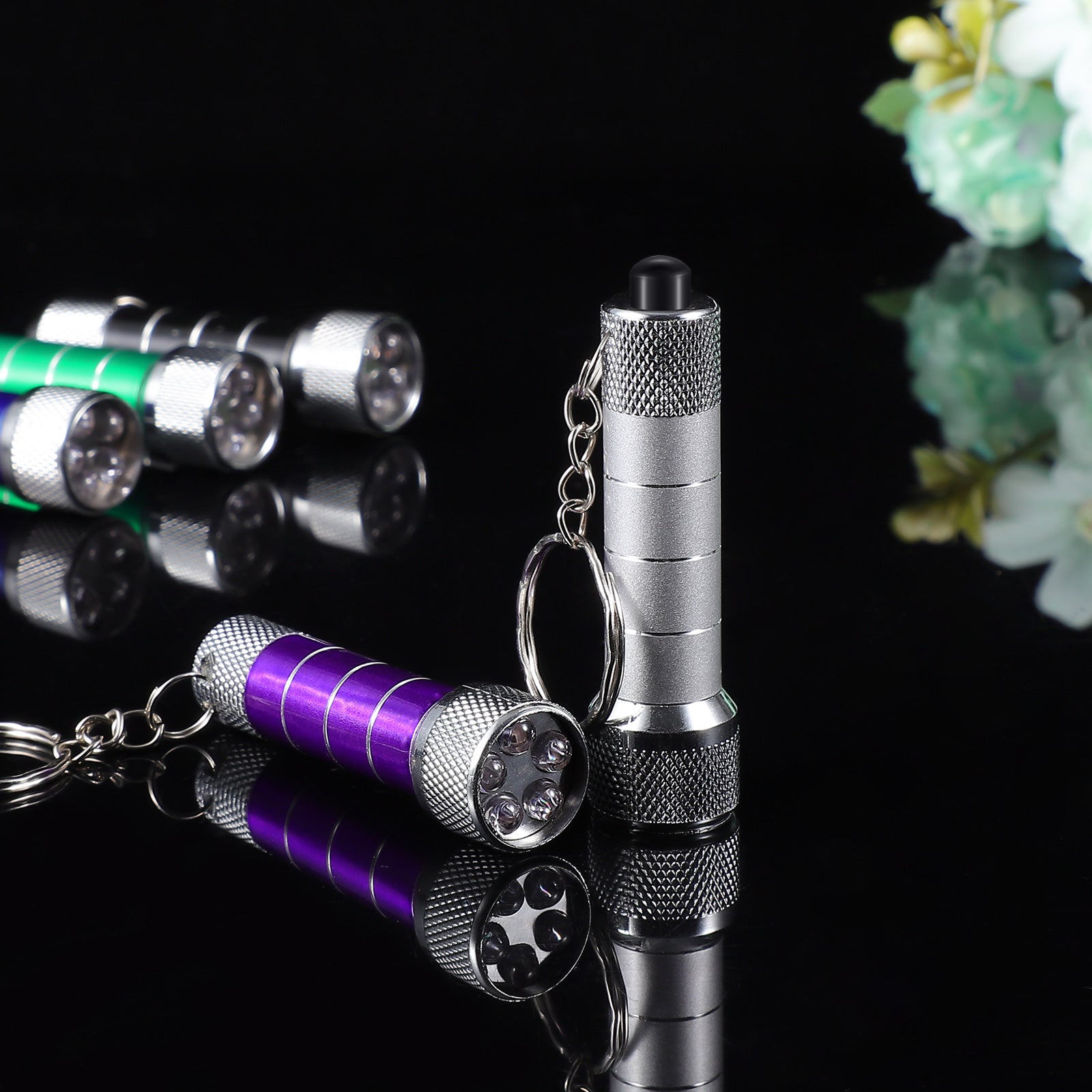 Aluminum LED keychain flashlight with purple tube and silver head, chain keyring