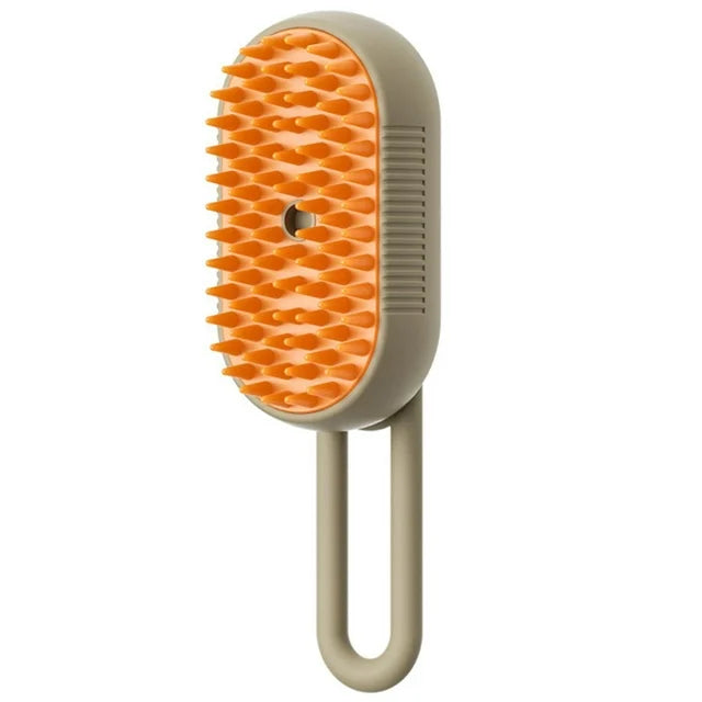 Electric steam pet grooming brush with orange bristle head and light beige handle