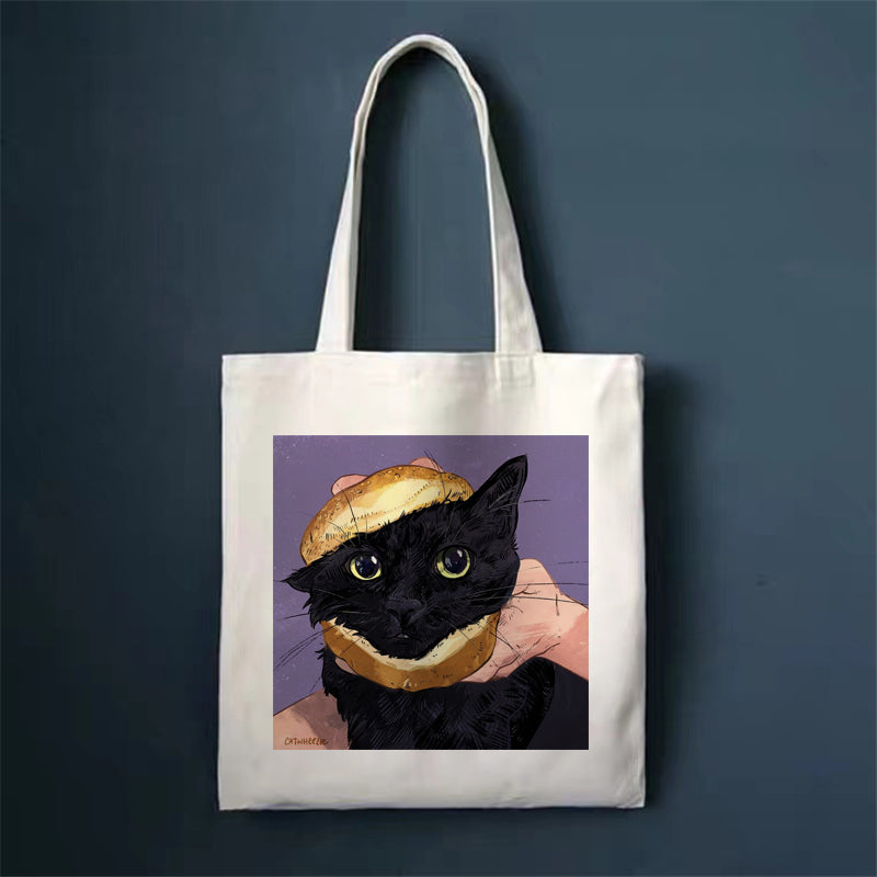 Canvas tote bag with black cat wearing a hat illustration, square front print and long handles