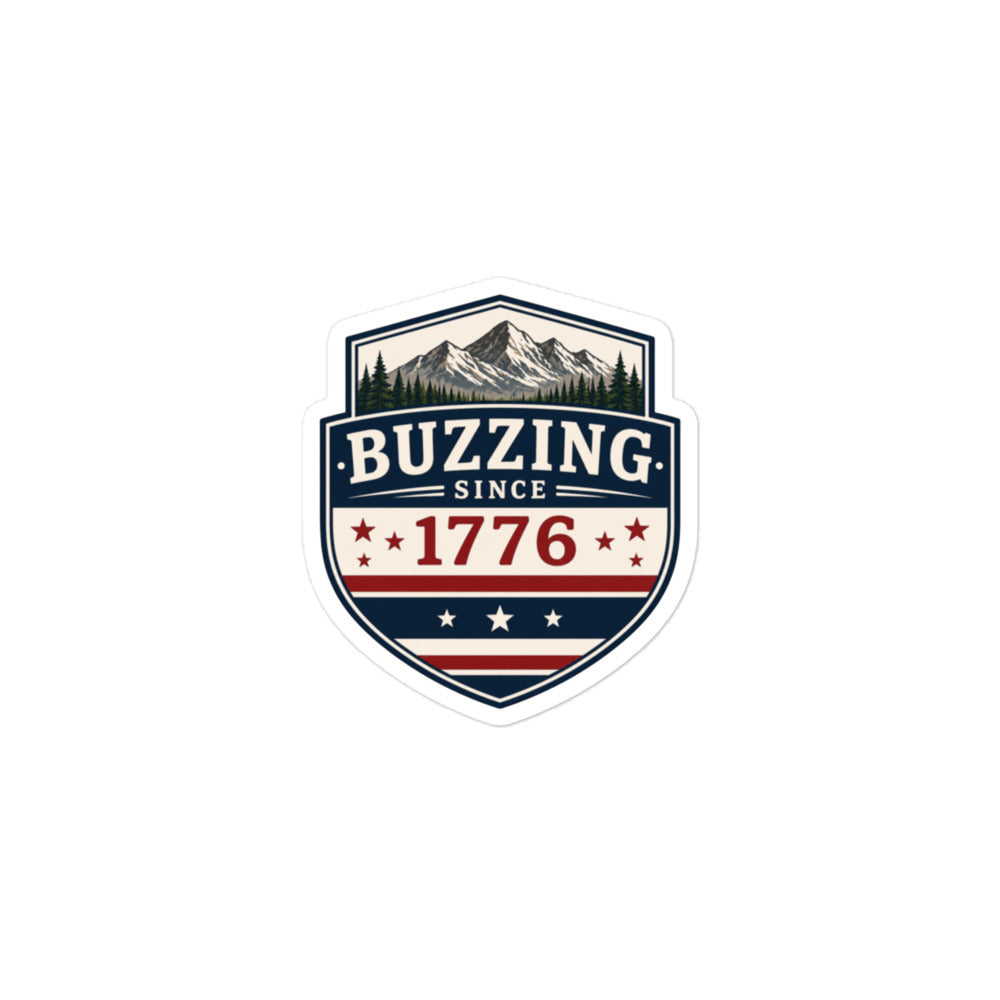 Shield-shaped sticker showing 'BUZZING' and 'SINCE 1776' with mountain scene and stars.