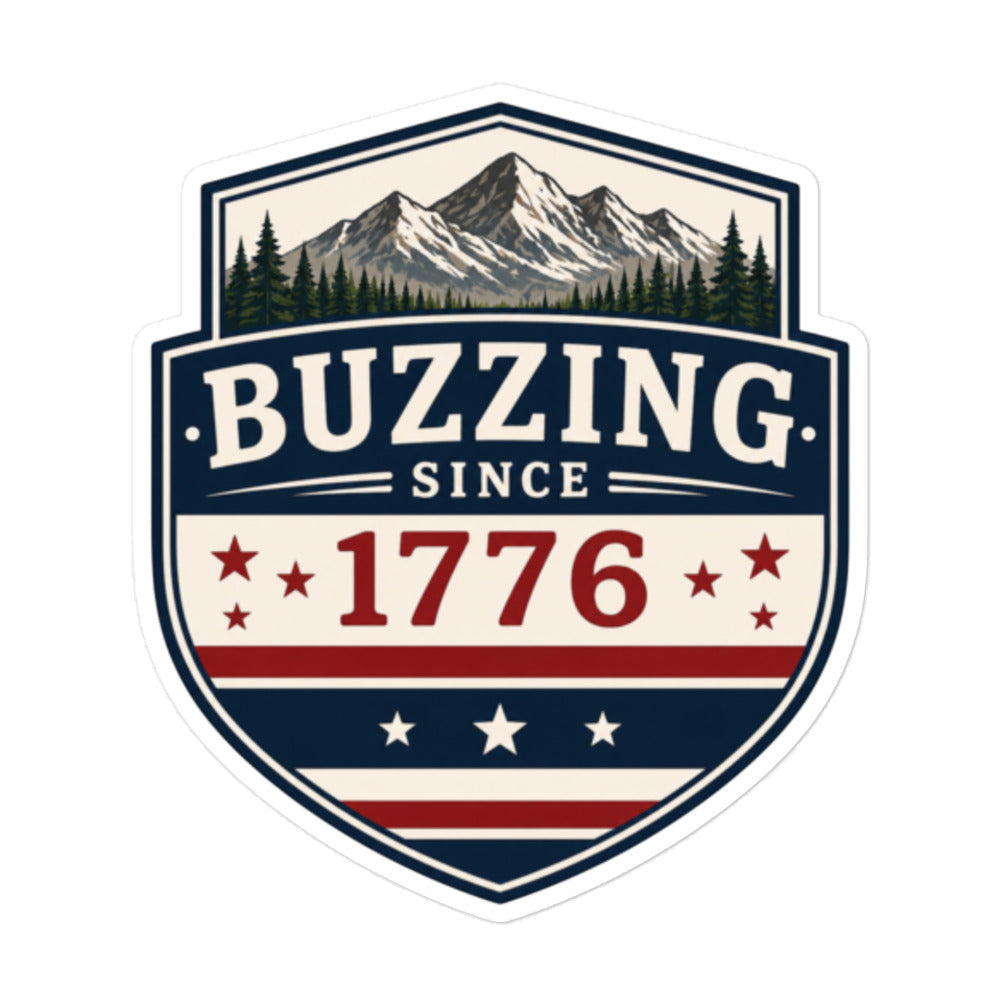 Shield-shaped sticker with 'BUZZING' and 'SINCE 1776' over mountains, stars, and stripes.