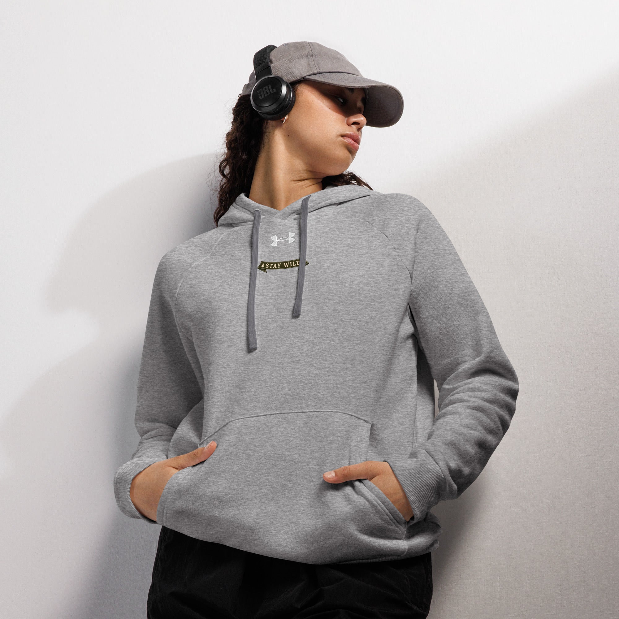 Gray Under Armour hoodie with front pocket, hood, and drawstring tips