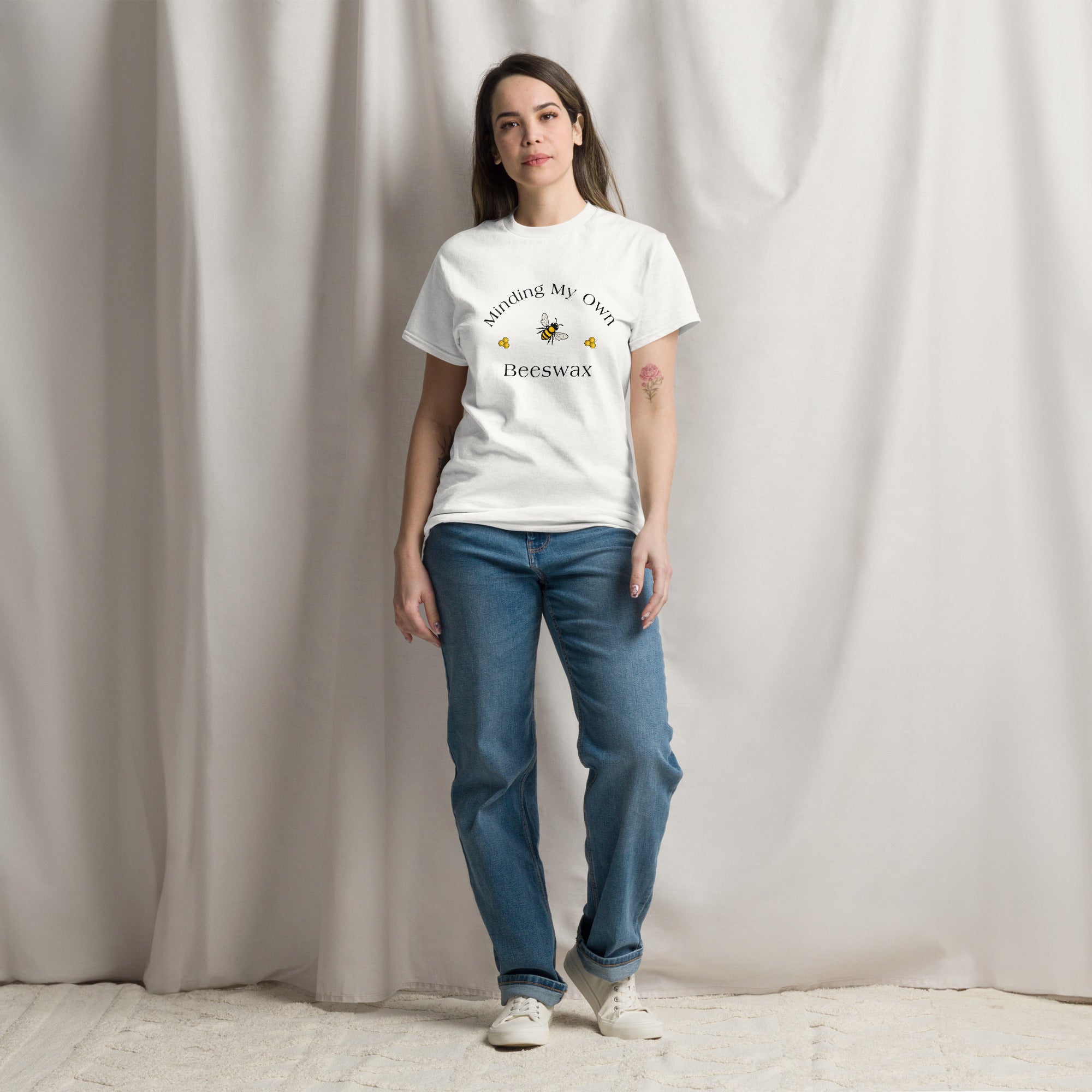 White unisex T-shirt with round neck and bee graphic with text on chest.