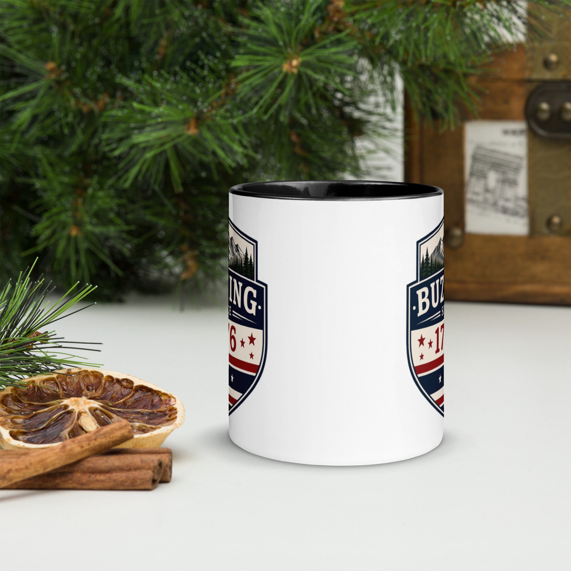 White ceramic mug with printed badge design and black interior rim
