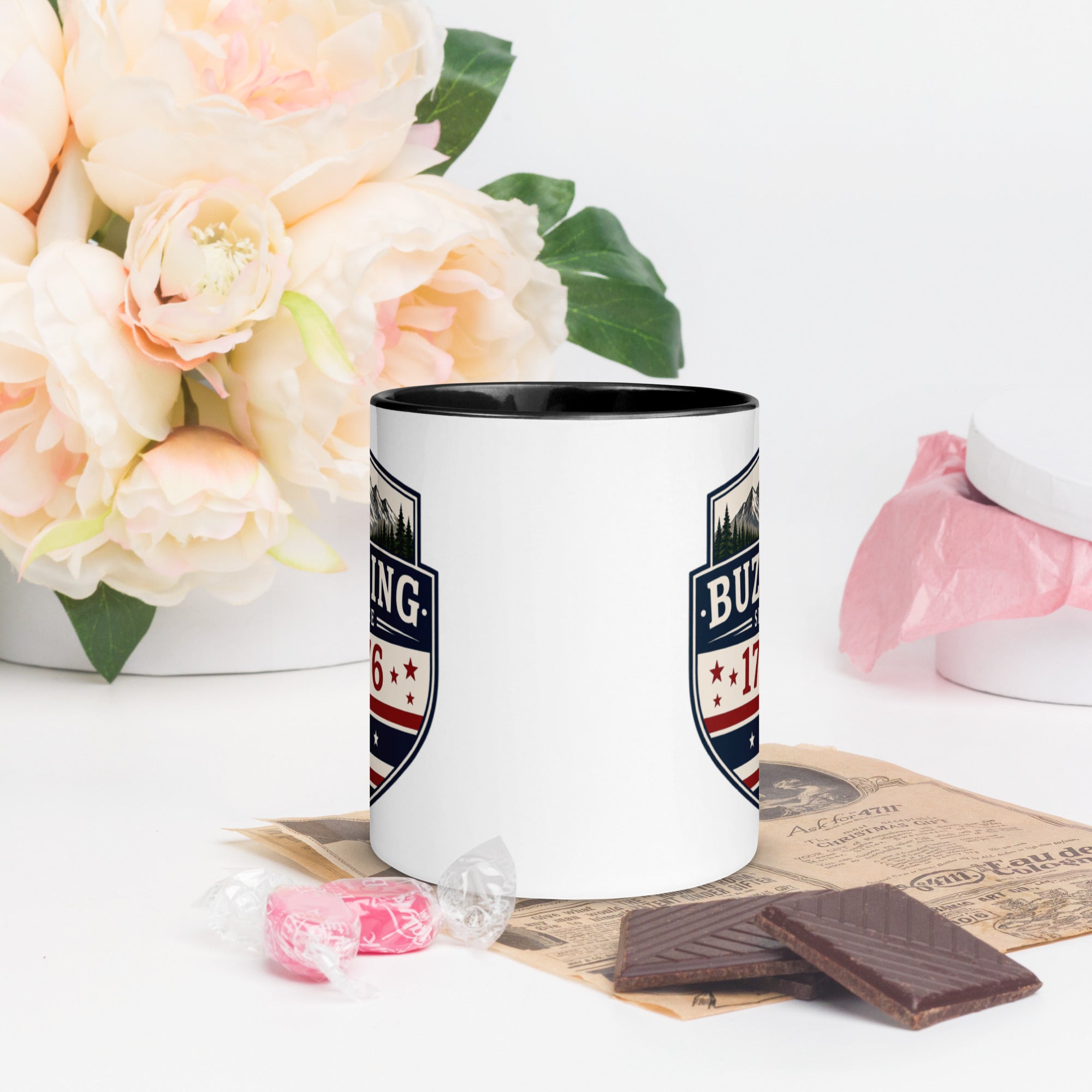 Color-inside ceramic mug with printed shield; black interior rim.