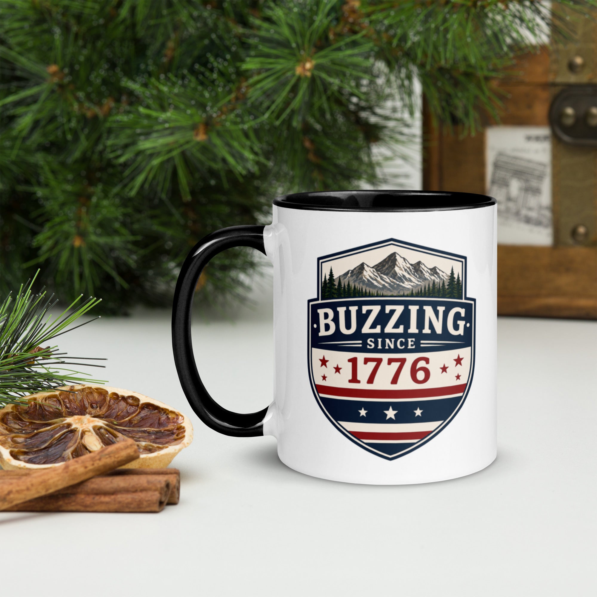 White ceramic mug with black rim and handle, shield logo reading 'Since 1776'