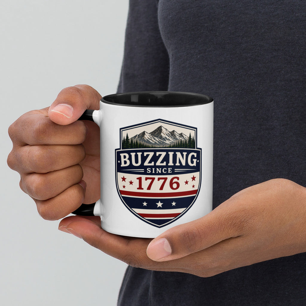 White ceramic mug with black interior, “Buzzing” 1776 crest graphic