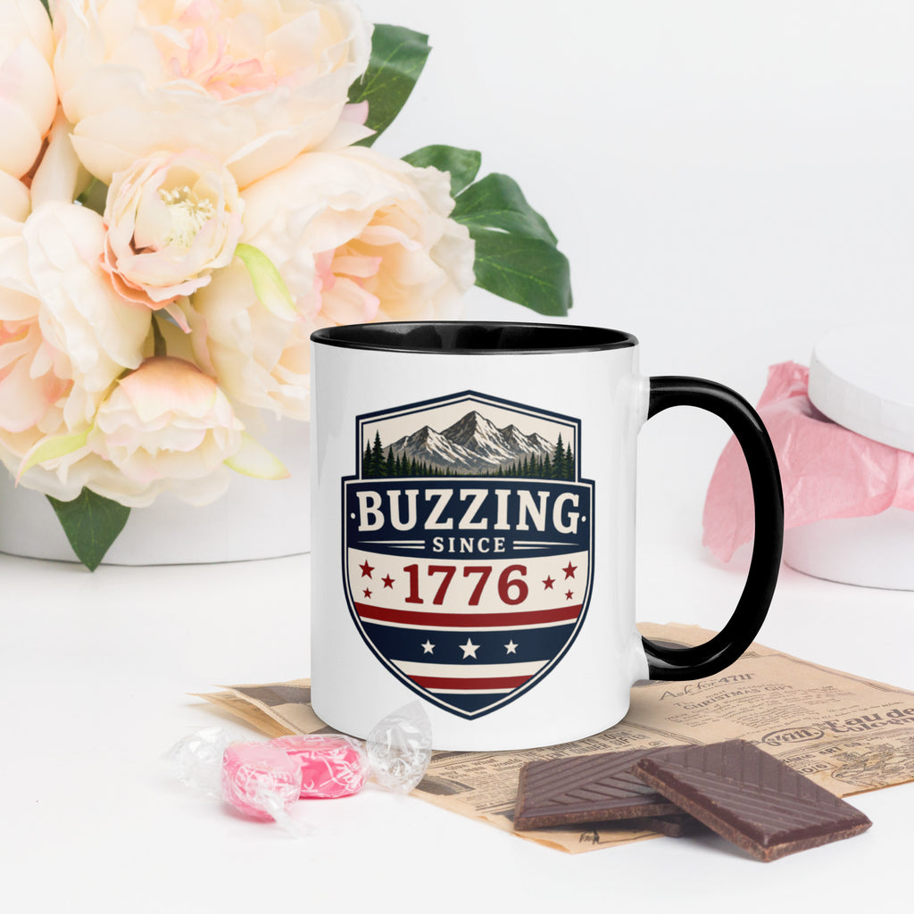 Ceramic mug with “1776” shield graphic, black rim and handle, white body.