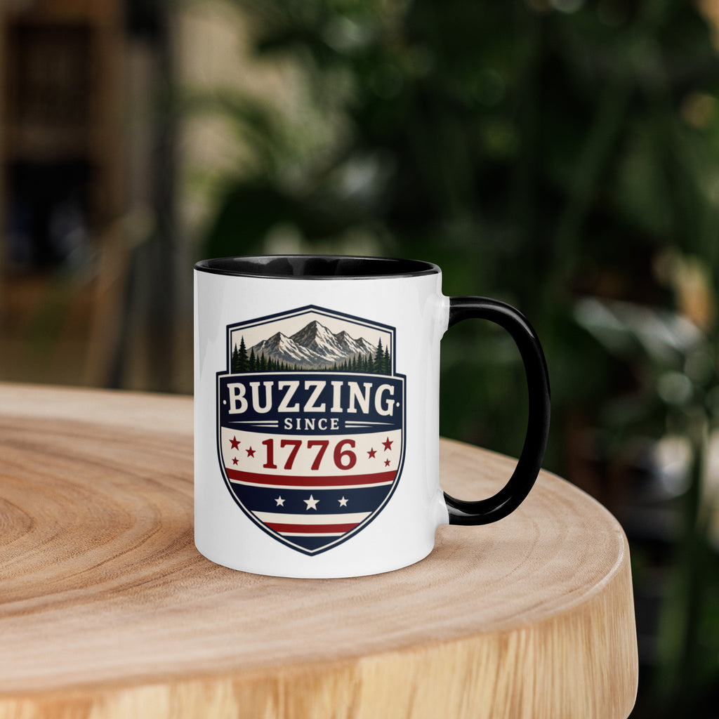 Coffee mug with black interior rim and handle, white body, “Buzzing Since 1776” graphic