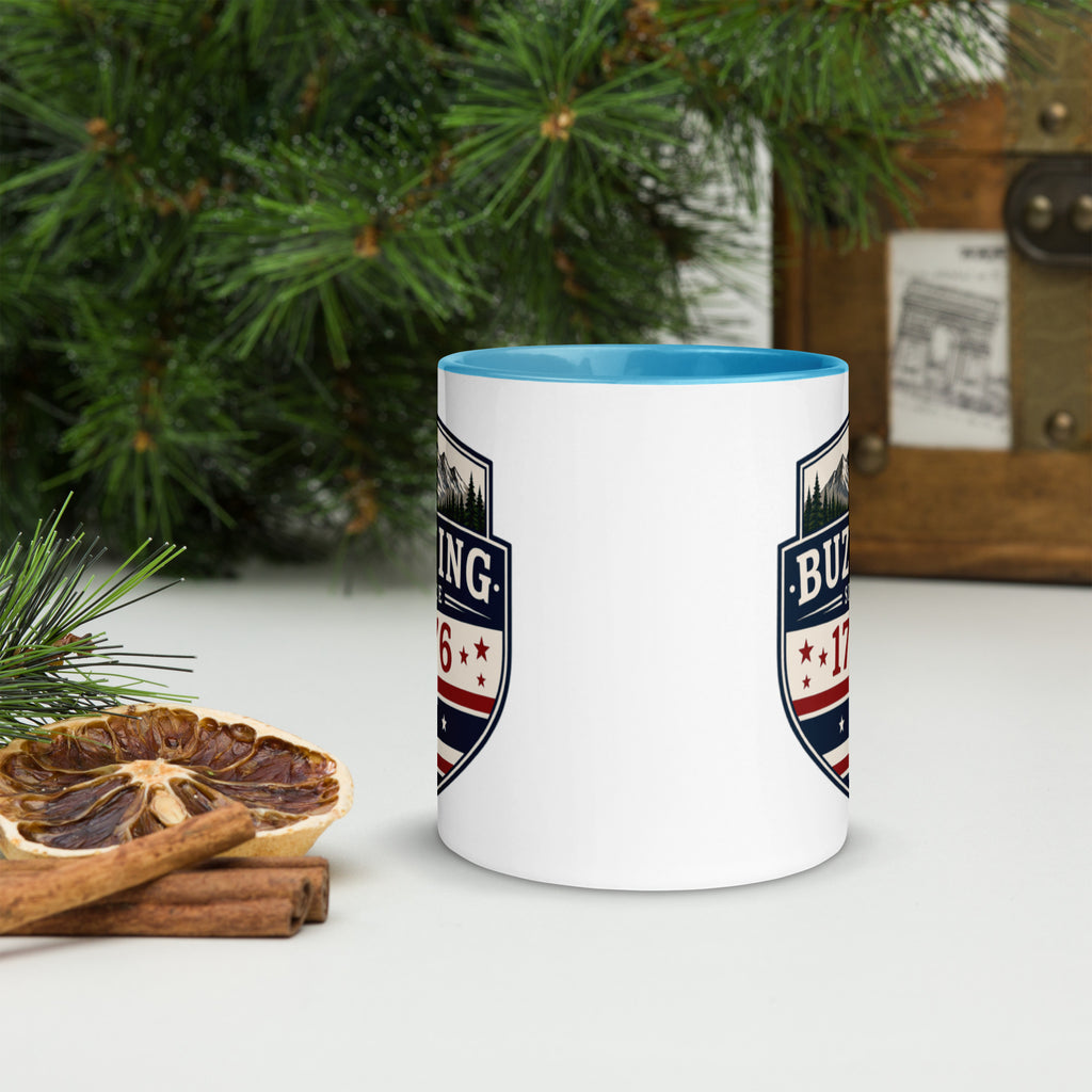 White ceramic mug with printed badge design and blue interior rim