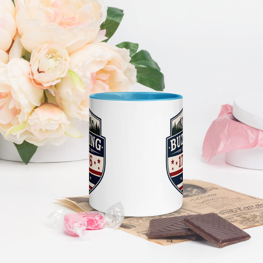 Color-inside ceramic mug with printed shield; blue interior rim.