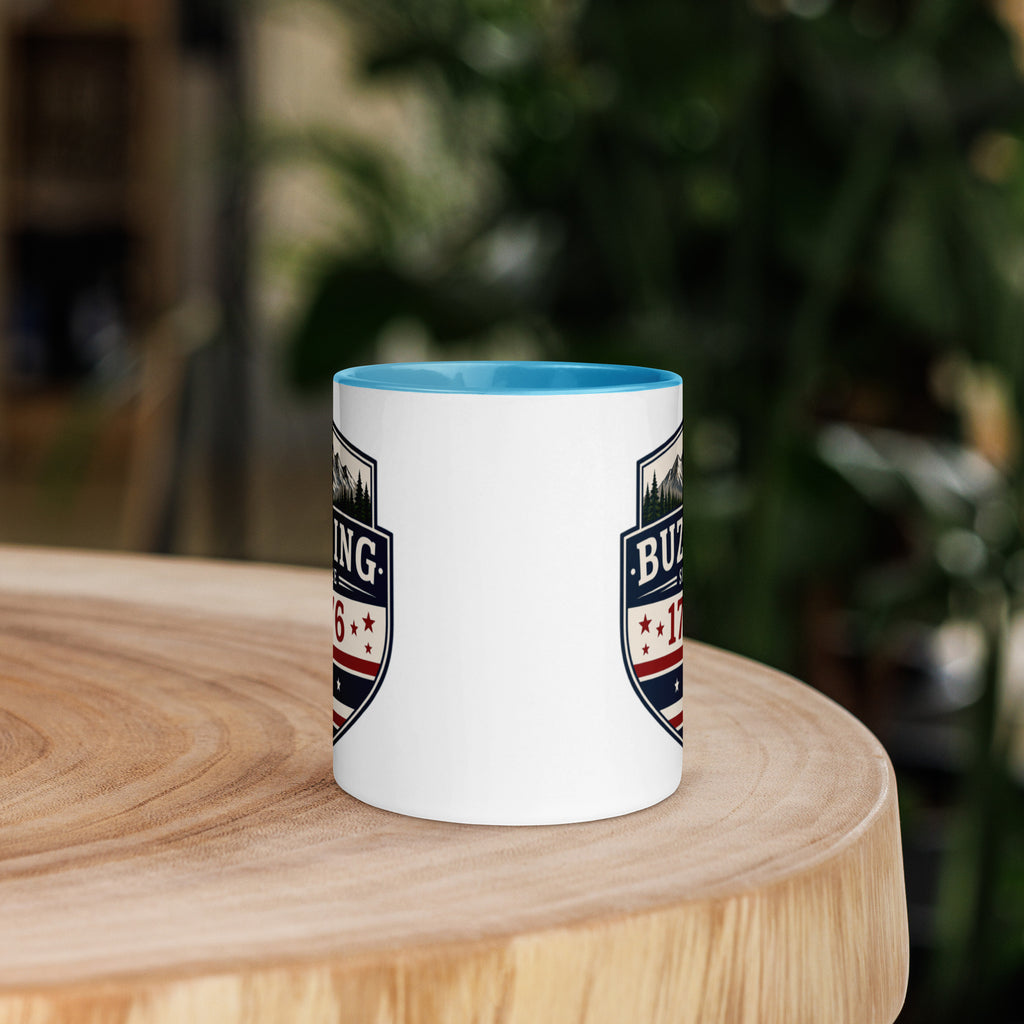 White coffee mug with blue interior and blue-red emblem print on sides
