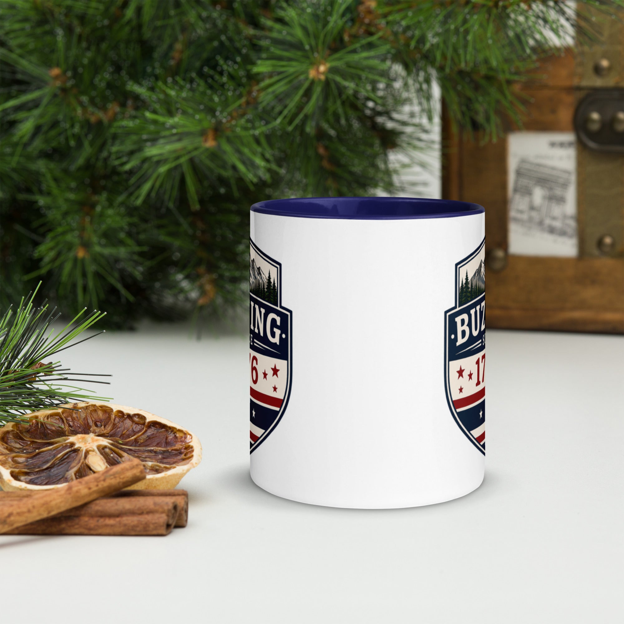 White ceramic mug with printed badge design and dark blue interior rim