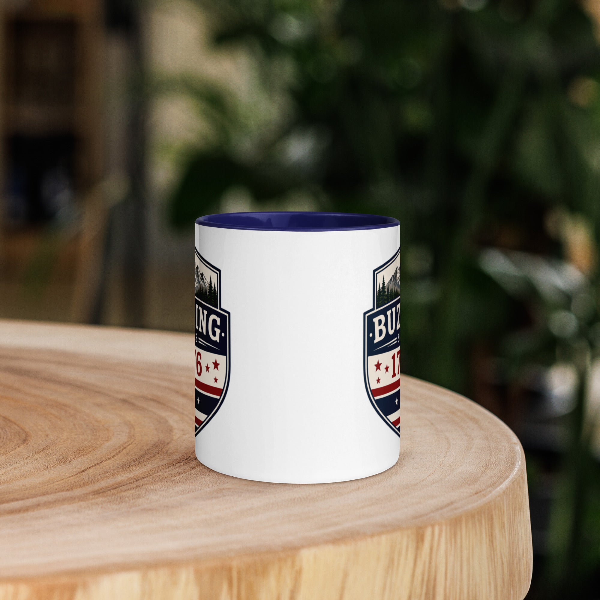 White coffee mug with dark blue interior and blue-red emblem print on sides