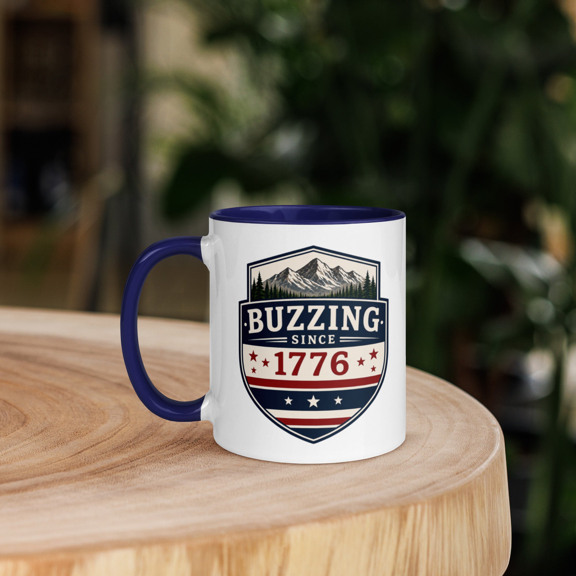 Mug with 'Buzzing Since 1776' crest, white body with dark blue handle and rim