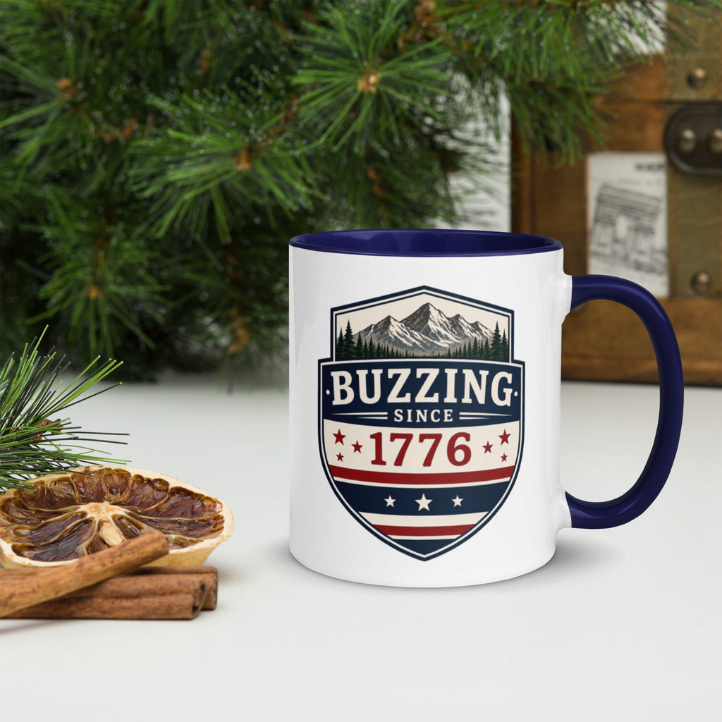 Ceramic mug with white body, dark blue interior and handle, BUZZING Since 1776 badge