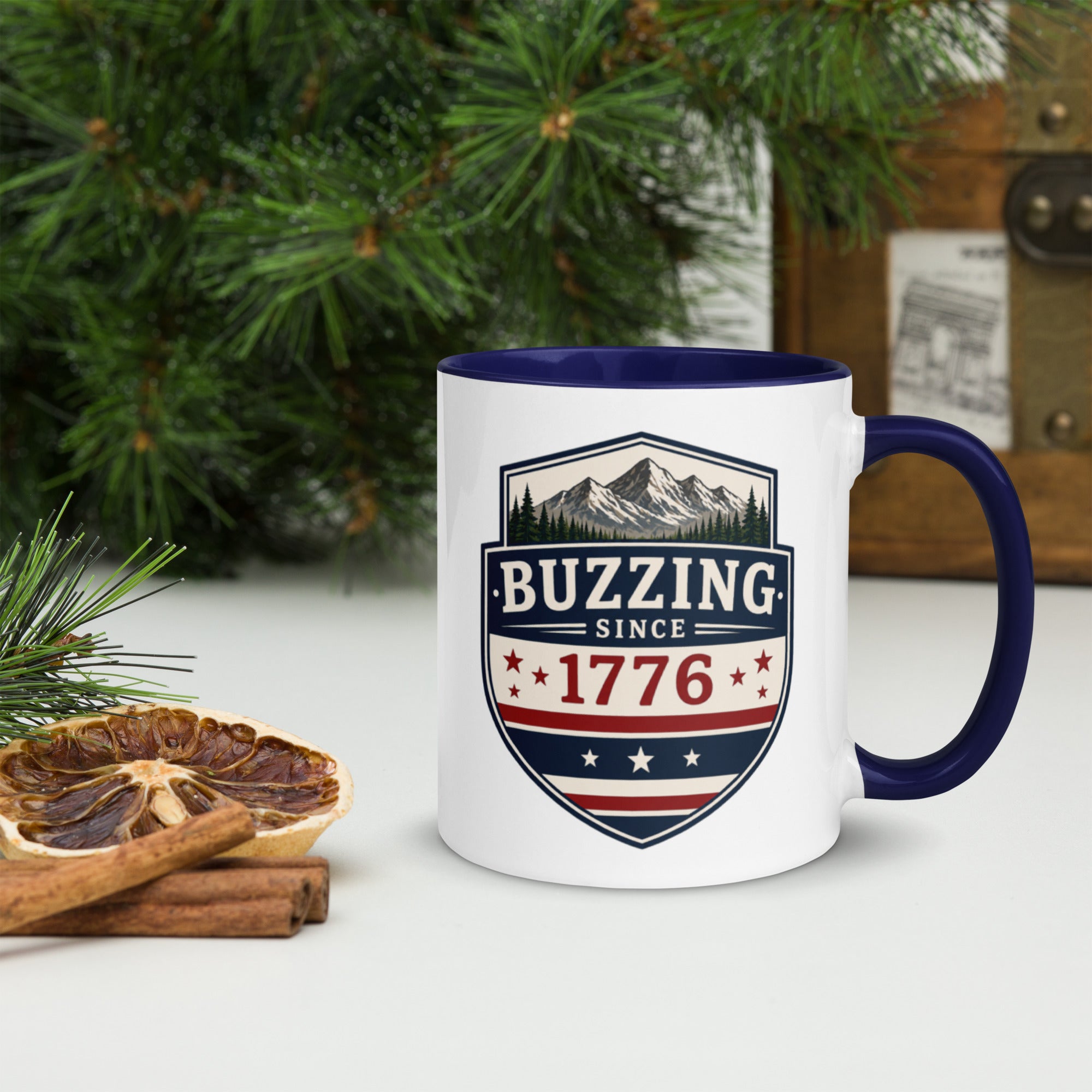 Ceramic mug with white body, dark blue interior and handle, BUZZING Since 1776 badge