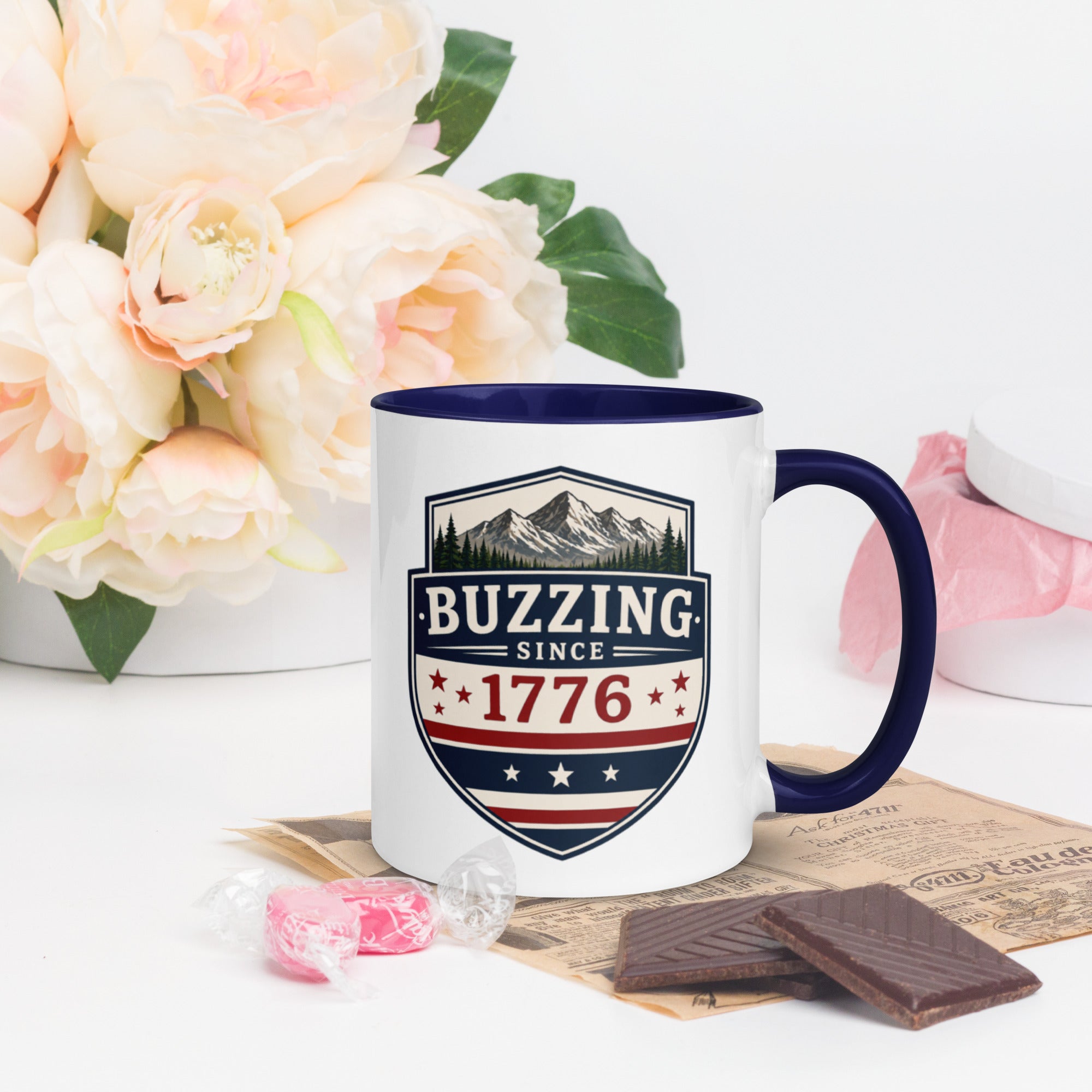 Ceramic mug with “1776” shield graphic, dark blue rim and handle, white body.