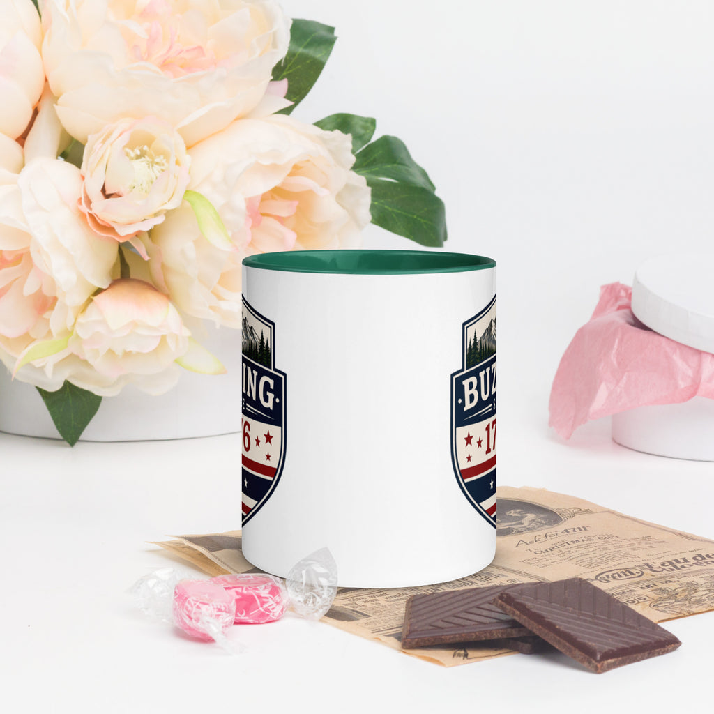 Color-inside ceramic mug with printed shield; dark green interior rim.