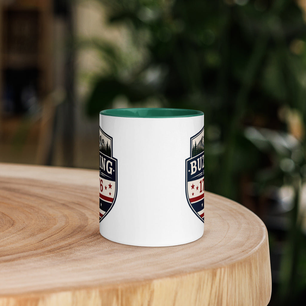 White coffee mug with dark green interior and blue-red emblem print on sides