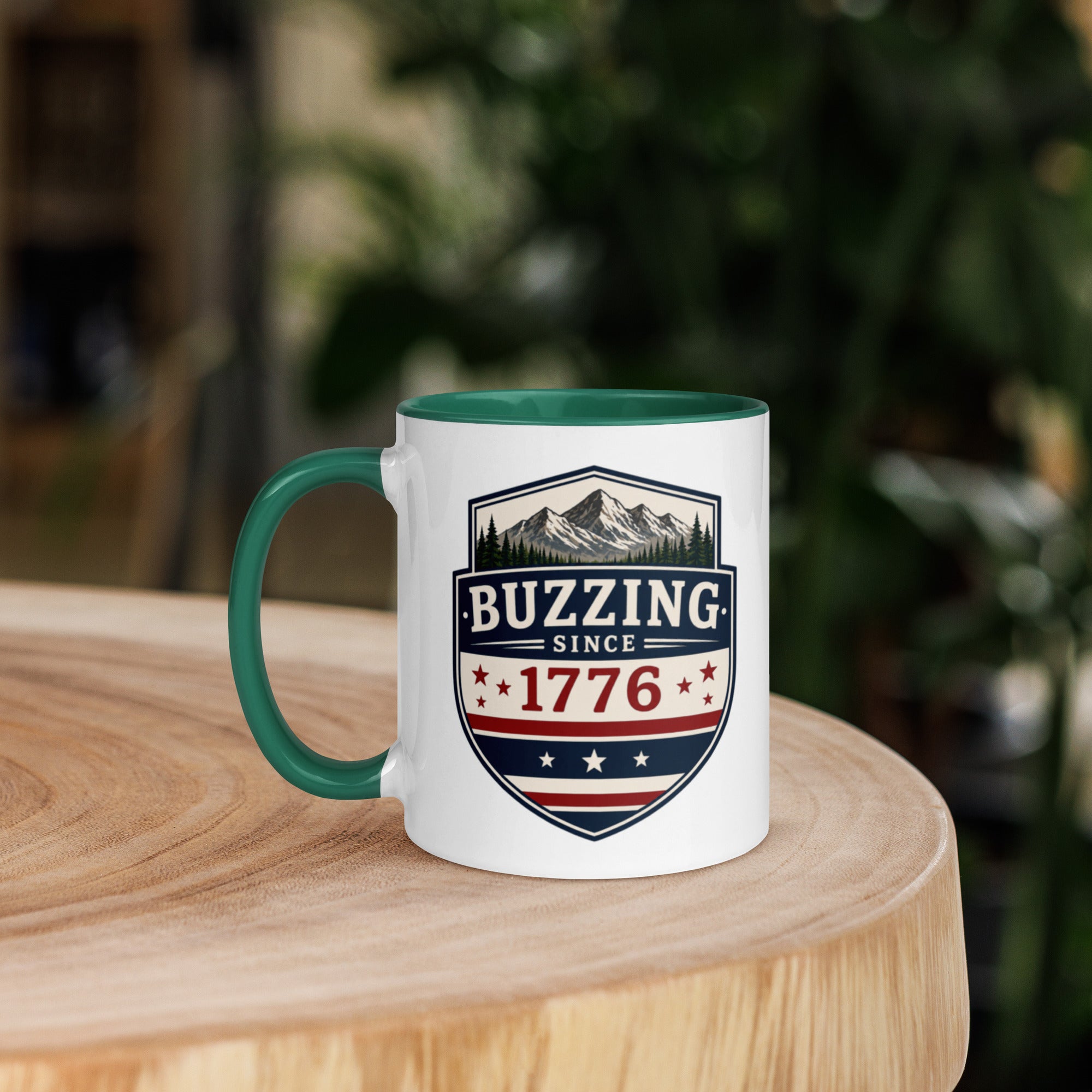 Mug with 'Buzzing Since 1776' crest, white body with dark green handle and rim