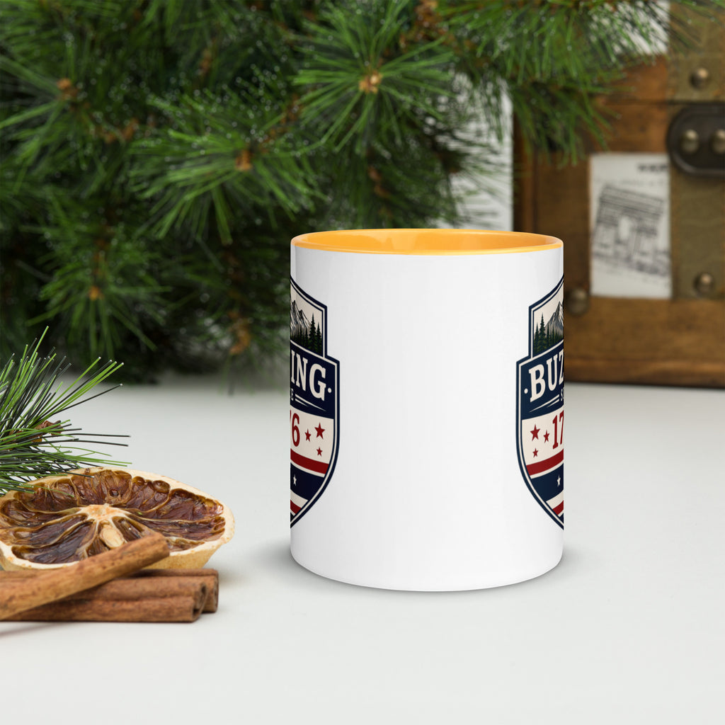 White ceramic mug with printed badge design and golden yellow interior rim