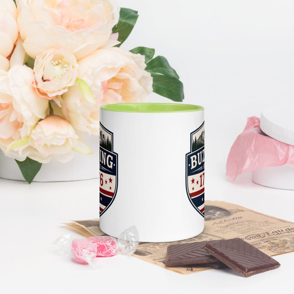 Color-inside ceramic mug with printed shield; green interior rim.
