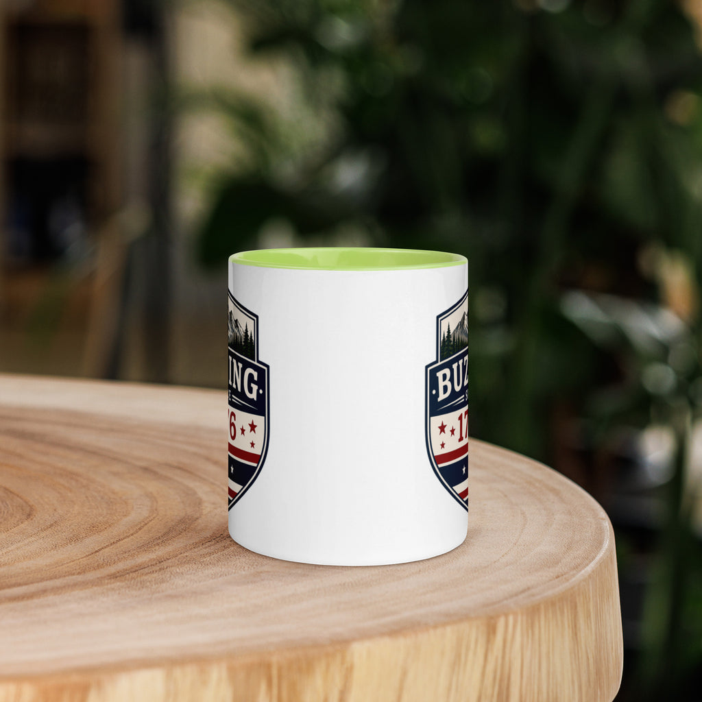 White coffee mug with green interior and blue-red emblem print on sides