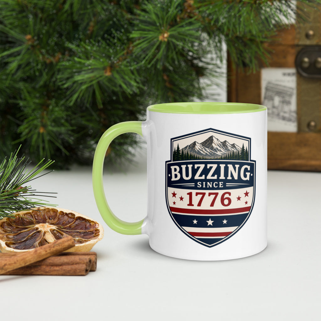 White ceramic mug with lime green rim and handle, shield logo reading 'Since 1776'