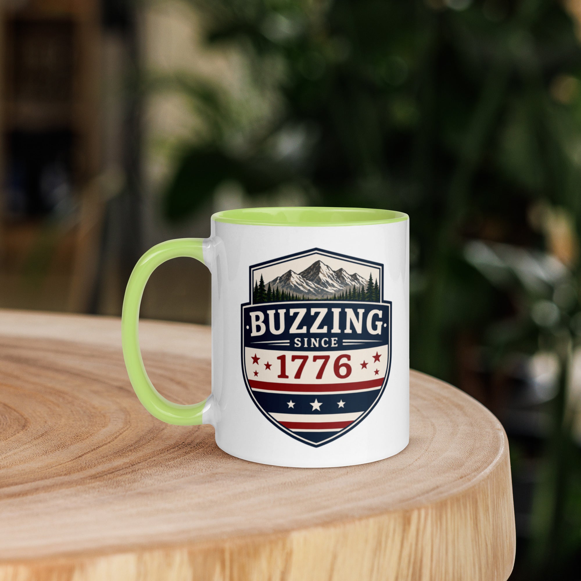 Mug with 'Buzzing Since 1776' crest, white body with green handle and rim