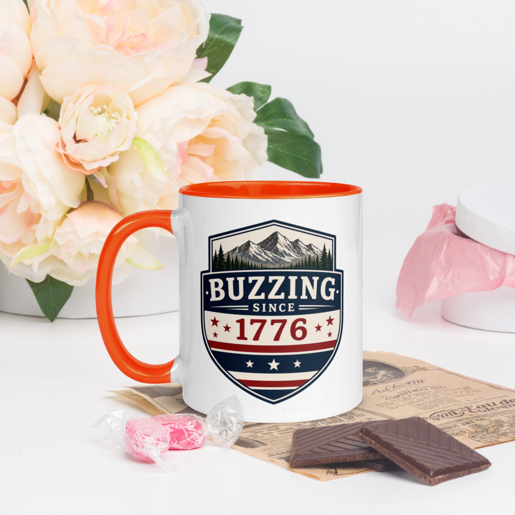 Ceramic mug with patriotic shield print, orange rim and handle