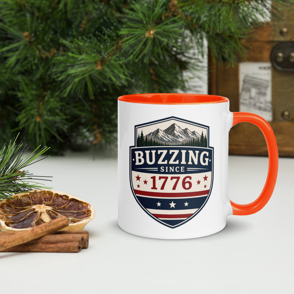 Ceramic mug with white body, orange interior and handle, BUZZING Since 1776 badge