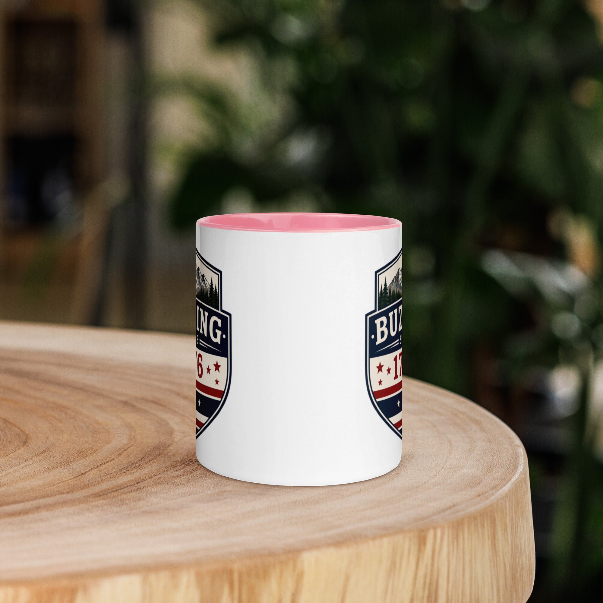 White coffee mug with pink interior and blue-red emblem print on sides
