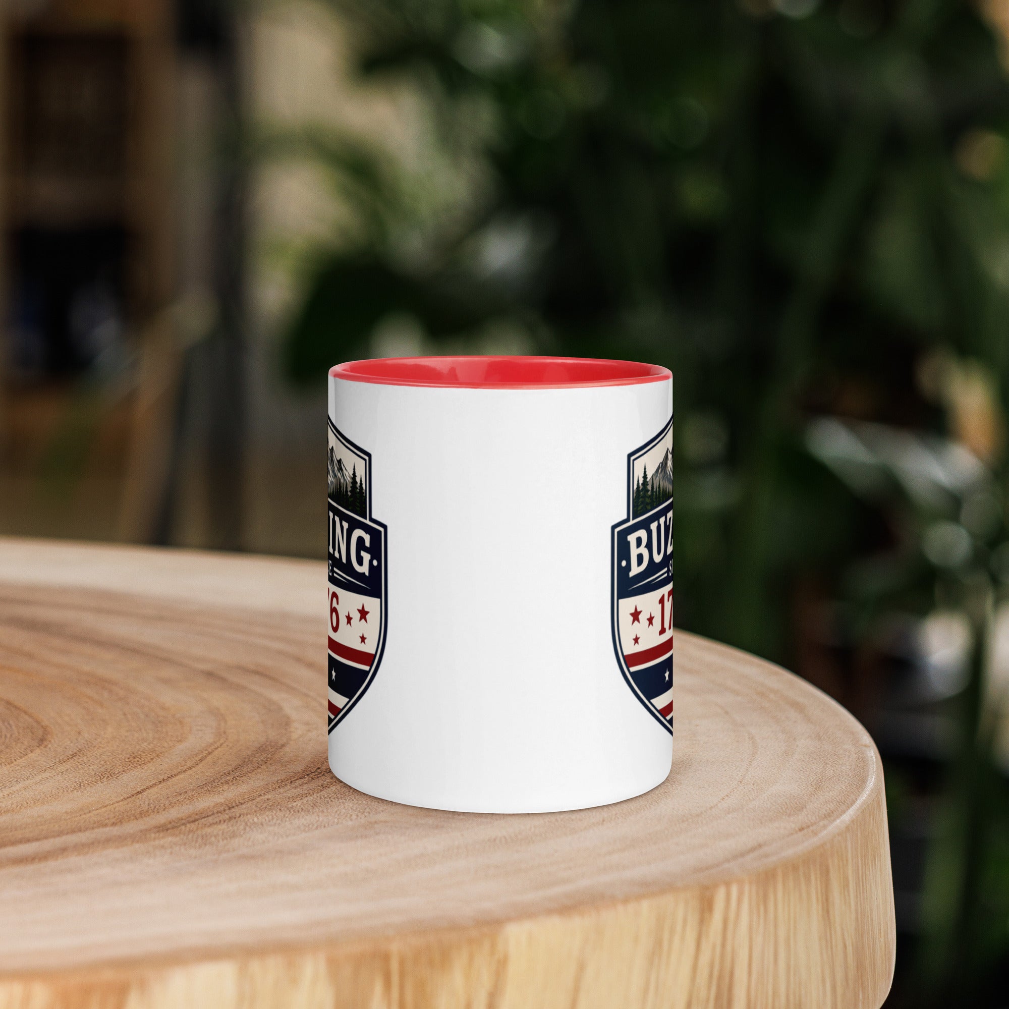 White coffee mug with red interior and blue-red emblem print on sides