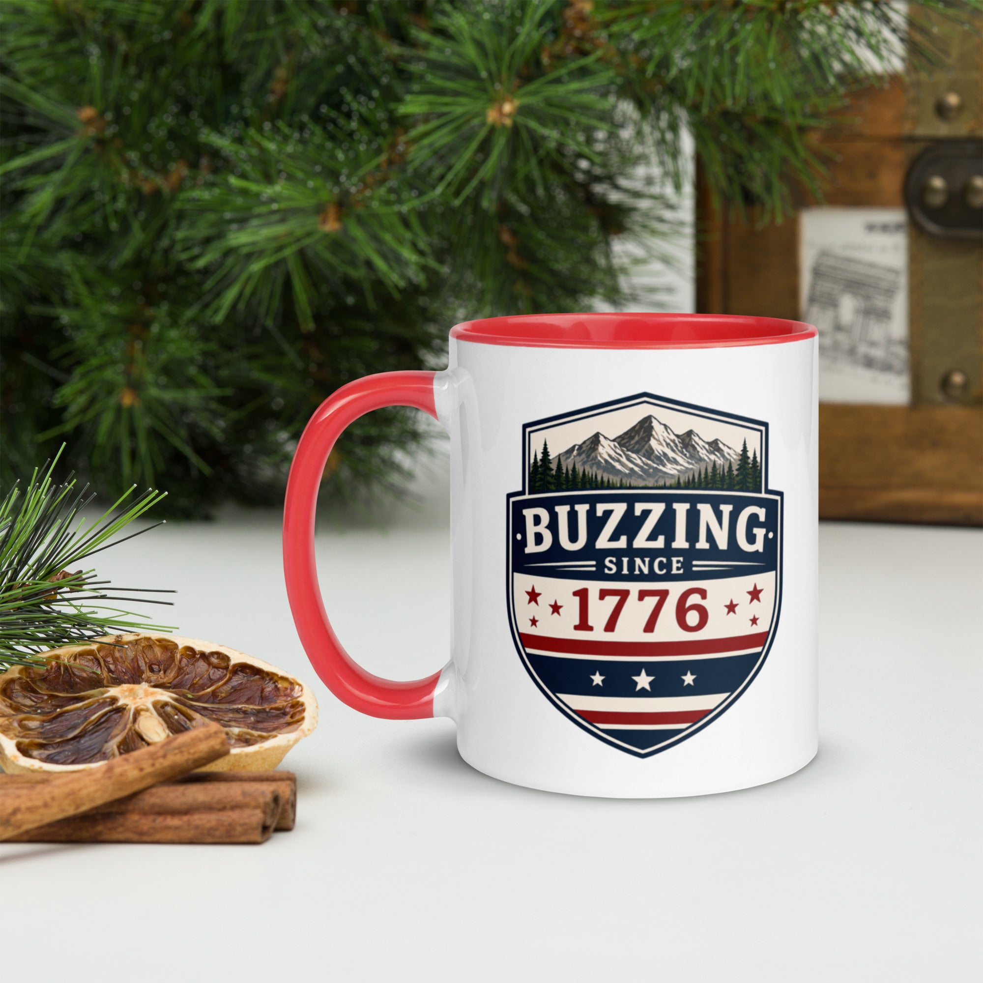 White ceramic mug with red rim and handle, shield logo reading 'Since 1776'