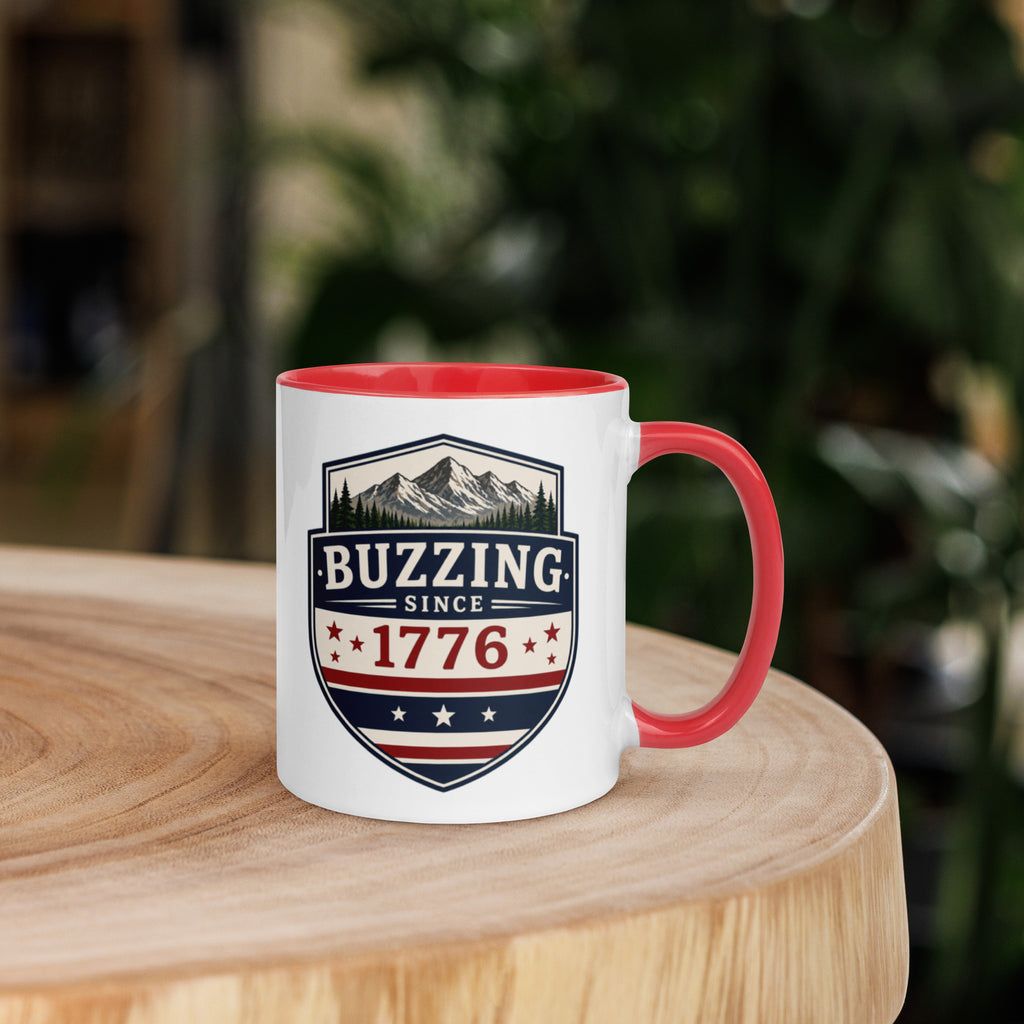 Coffee mug with red interior rim and handle, white body, “Buzzing Since 1776” graphic