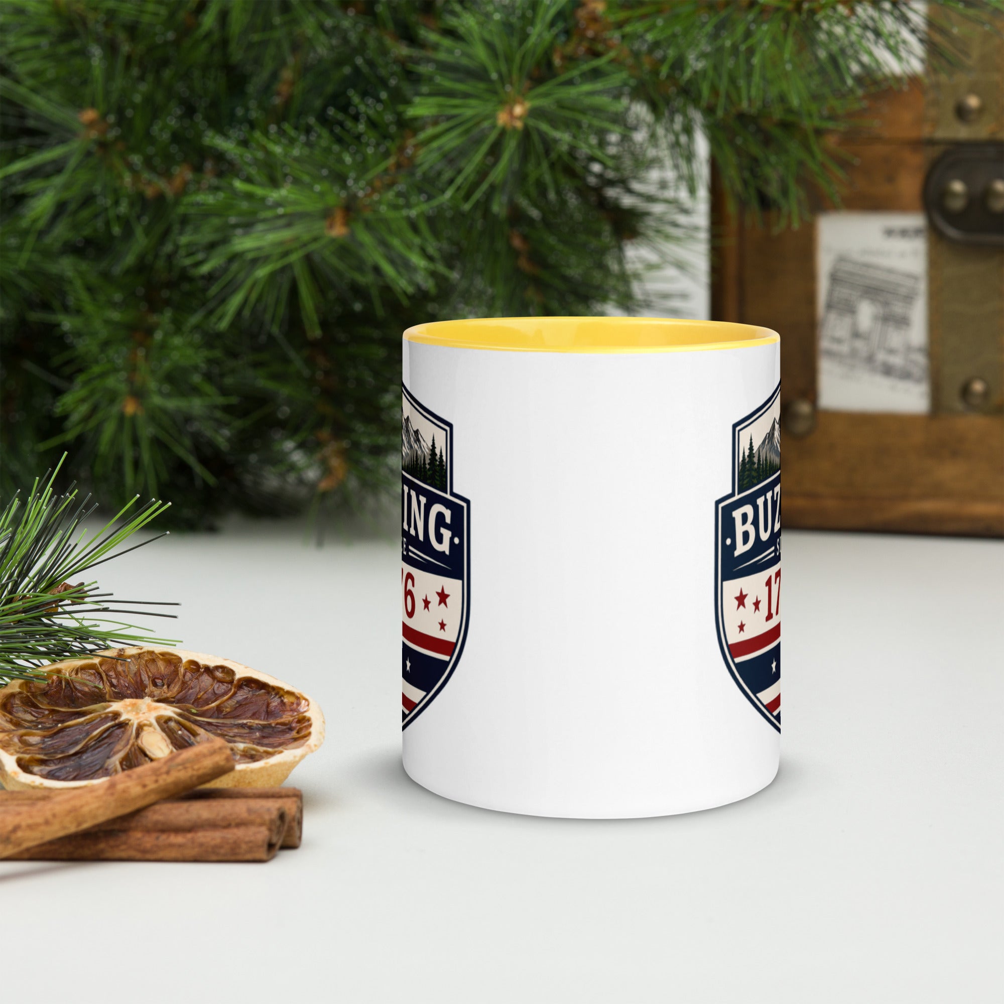 White ceramic mug with printed badge design and bright yellow interior rim