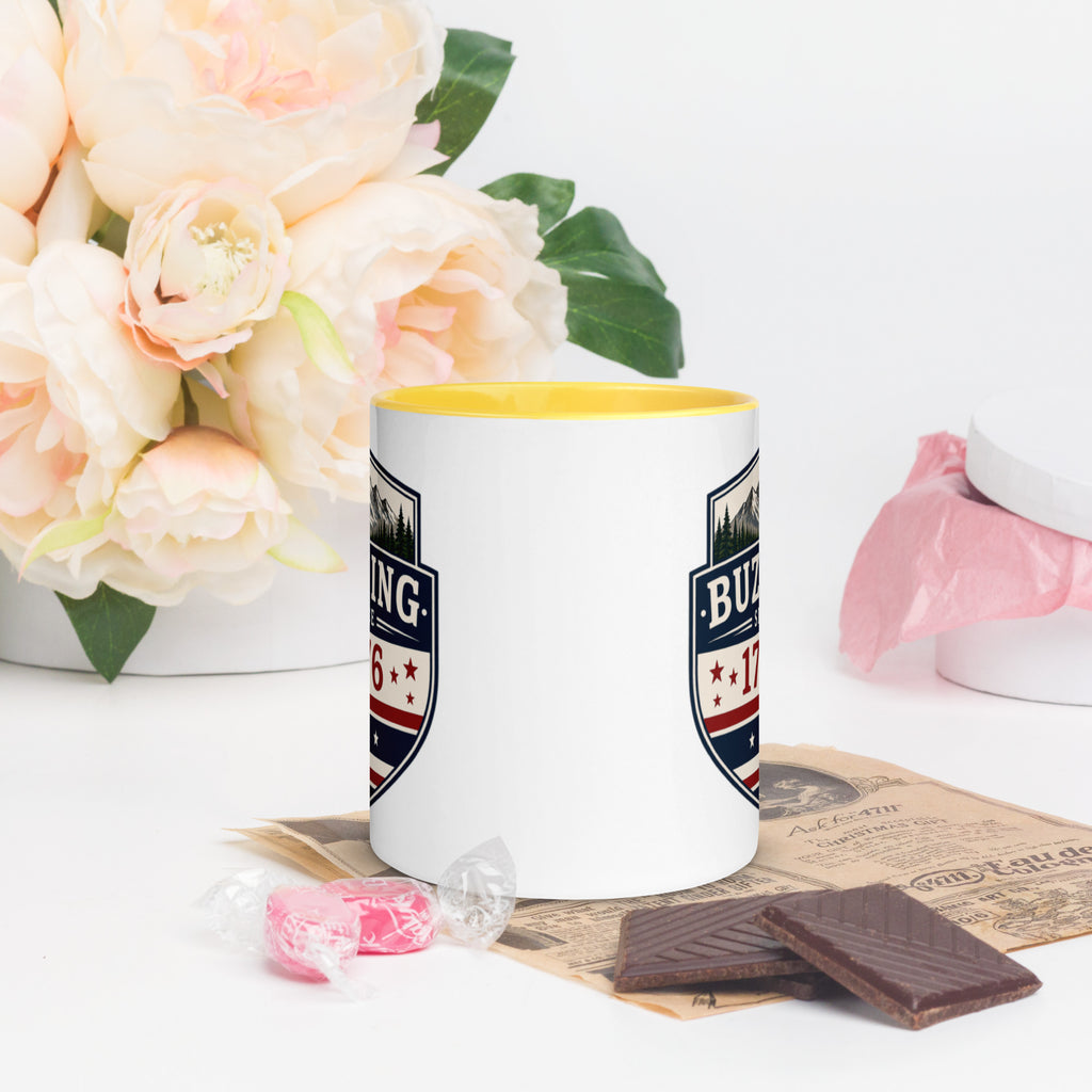 Color-inside ceramic mug with printed shield; yellow interior rim.