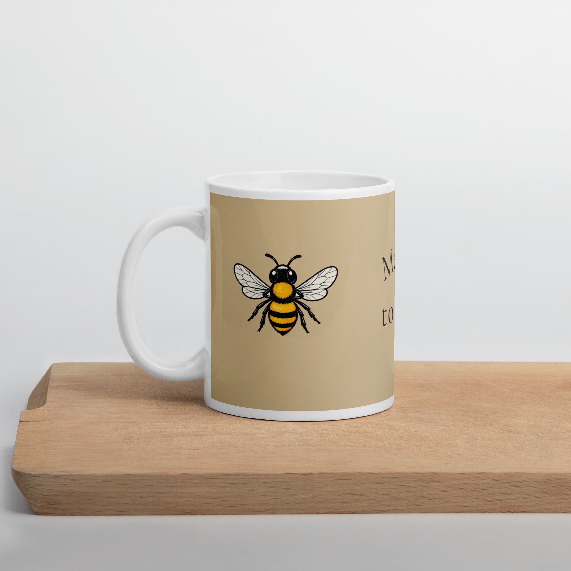 Beige ceramic mug with bee decal and white handle